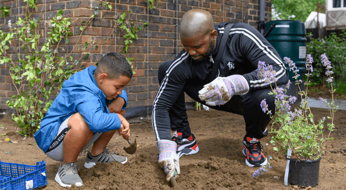 Man and boy digging in mud
