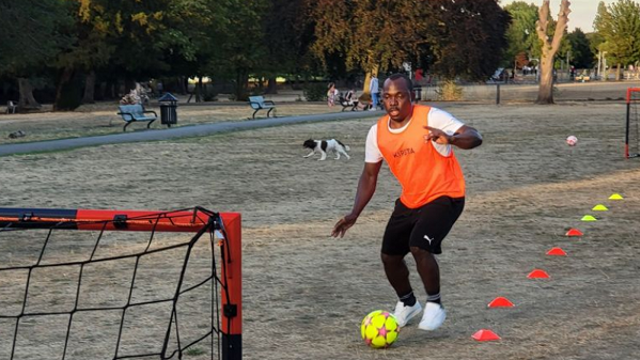 Man kicking a yellow ball