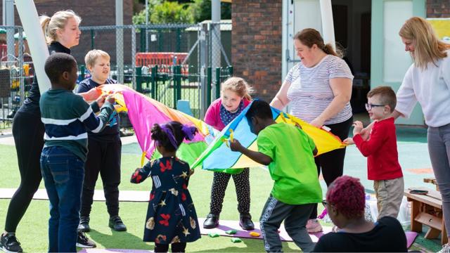 Adults and children playing