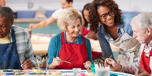 People sitting at a table doing art