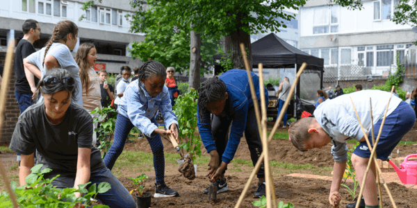 Group of people digging in mud