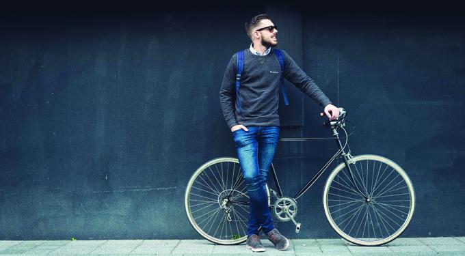 Man looking away from the camera with a bike