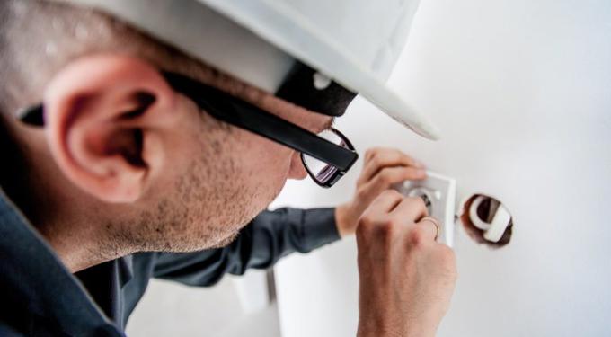 Man wearing a hard hat and glasses